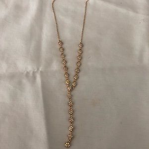 A gold “Y” jeweled necklace